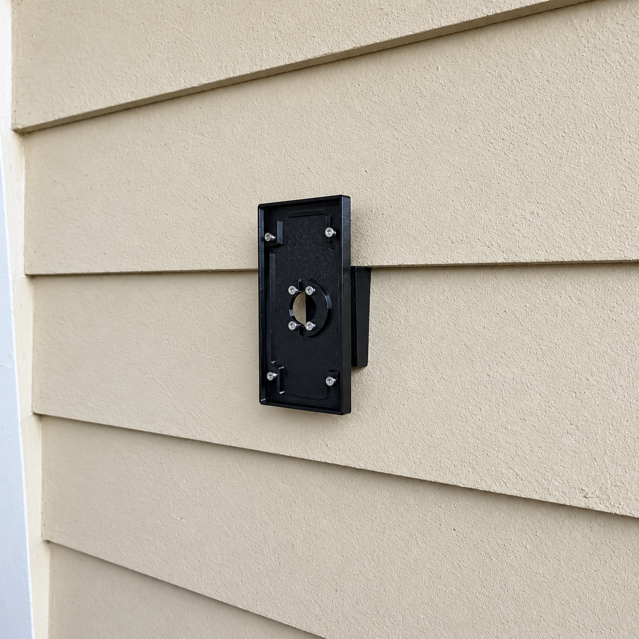Black mount installed in a fiber cement siding lap joint